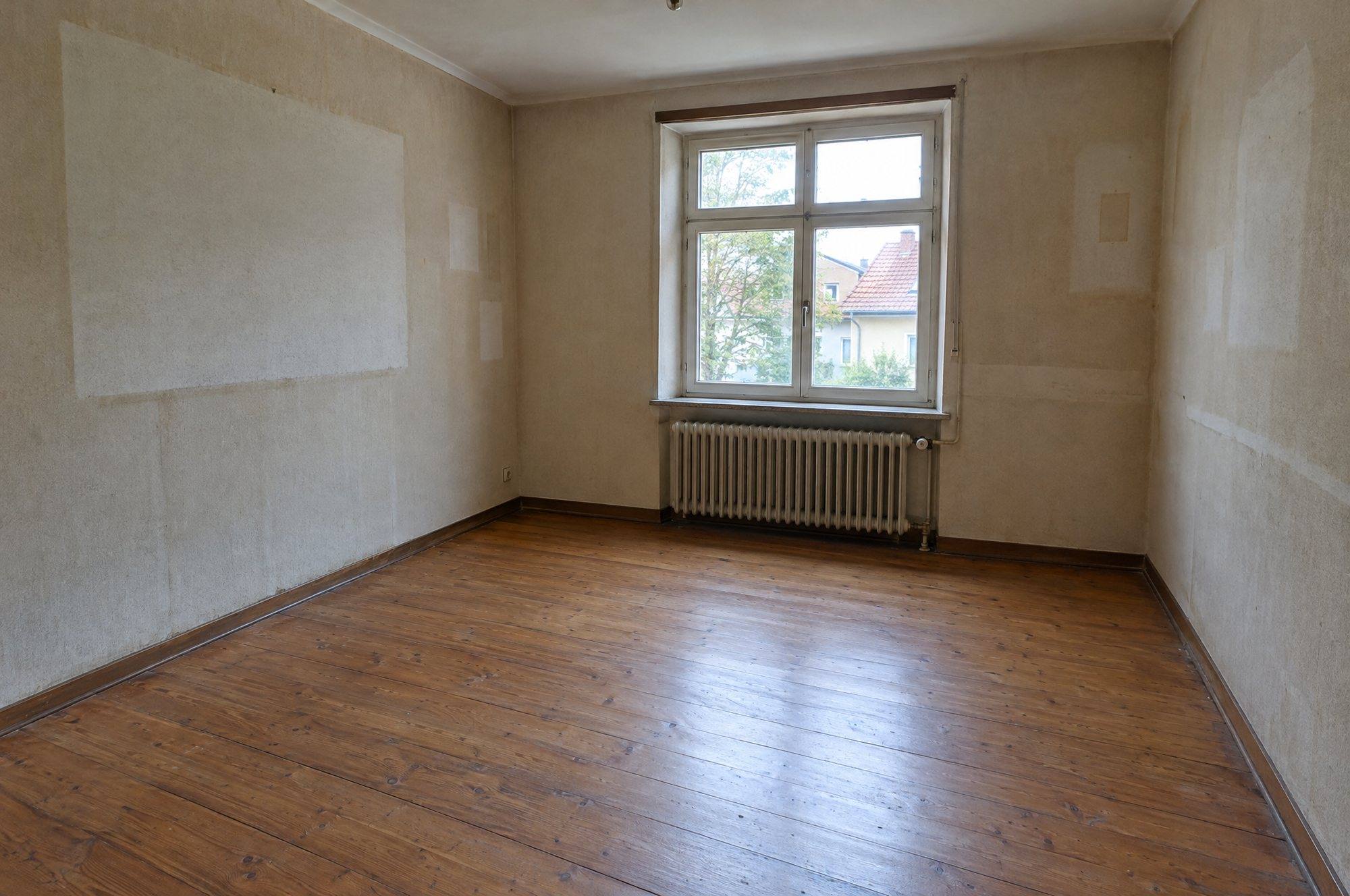 Leerer, gefegter Raum mit Holzdielen nach der Haushaltsauflösung